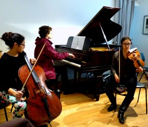 Caitlin and Audrey work with Sean on 'expanding' his piano piece into a chamber work